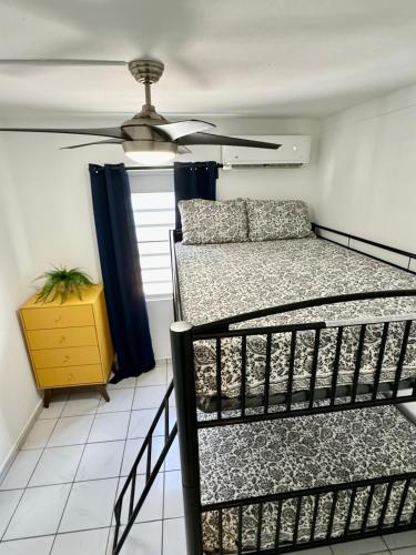 a bedroom with a bed and a ceiling fan at Casa Agave Oasis Levittown in Toa Baja