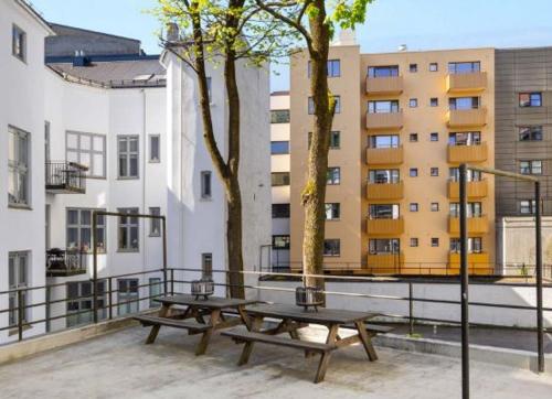 two picnic tables on a balcony of a building at Professor Dahls Gate 16 in Oslo