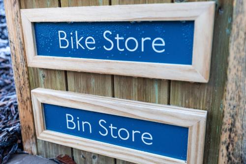 two signs that say bike store and bin store at Rock Mill 1 Bed Apartment 37 in Stoney Middleton