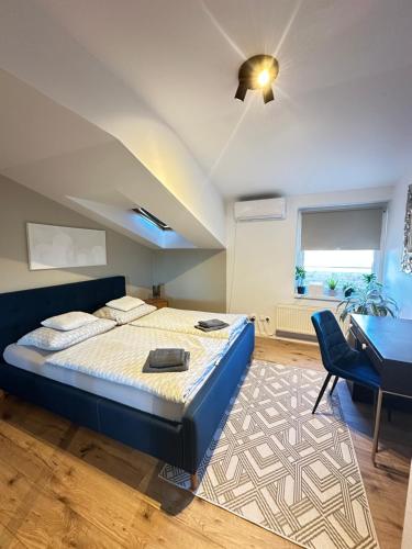 a bedroom with a bed and a desk and a chair at Samorin City apartment with terrace in Šamorín