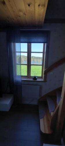 a room with a window with a view of a field at Djurstagården Ängslyckan in Jättendal