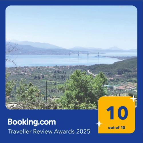 a yellow sign with a view of a river and a bridge at Up on the hill in Nafpaktos