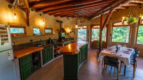 a kitchen with green cabinets and a dining table at Terracota Eco-Casa Intiyaco 6 Pax in Atos Pampa
