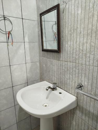 a bathroom with a white sink and a mirror at Lar da Elis in Riacho Fundo