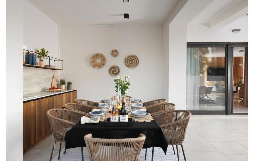 a dining room with a table and chairs at Lovely Home In Zambratija With Kitchen in Zambratija