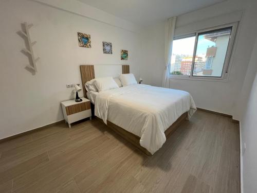 Ένα ή περισσότερα κρεβάτια σε δωμάτιο στο apartamento el copo