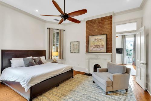 a bedroom with a bed and a fan and a chair at Garden District Historic Home Near Wwii Museum in New Orleans