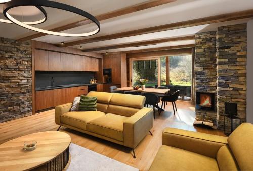 a living room with a couch and a table at Chalet Oasis - Luxury Retreat at Chalets Kvačianska Dolina in Zuberec