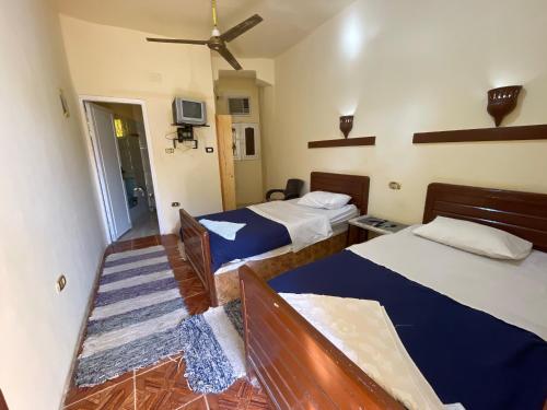 a hotel room with two beds and a television at Ahmed Safari Camp in Bawati