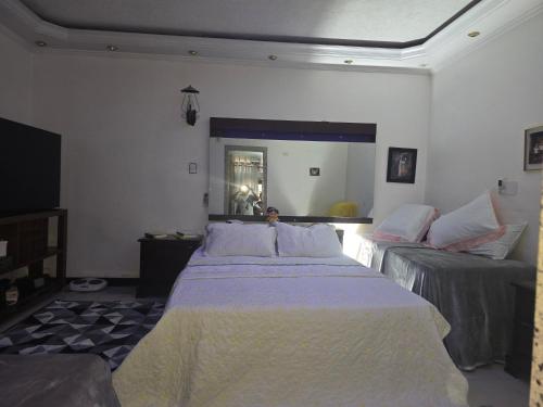 a bedroom with two beds and a large mirror at Espaço TOP São Paulo - Brazil in Sao Paulo