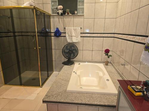 a bathroom with a sink in the middle of a shower at Espaço TOP São Paulo - Brazil in Sao Paulo