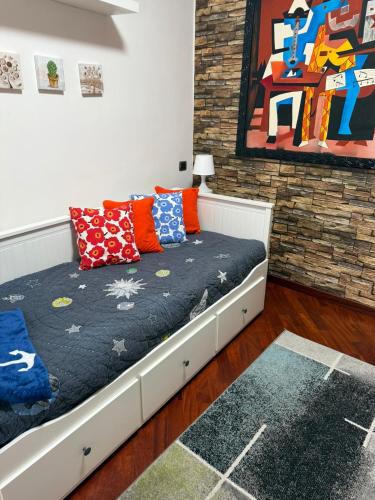 a bed with pillows on it in a room at Marebleuhouse in Naples