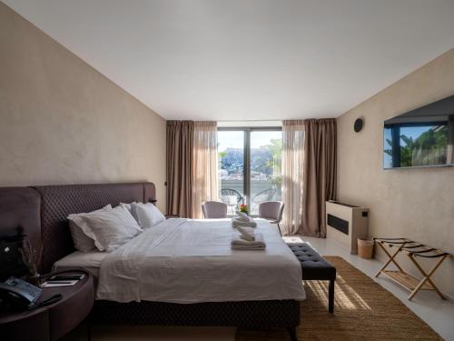 a bedroom with a bed and a large window at Regal Hotel Mitropoleos in Athens