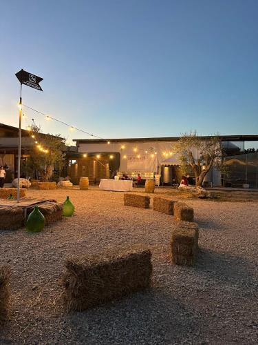a group of hay bales on the ground in front of a building at B&B Biobonizio PIERLUIGI in Montegrosso