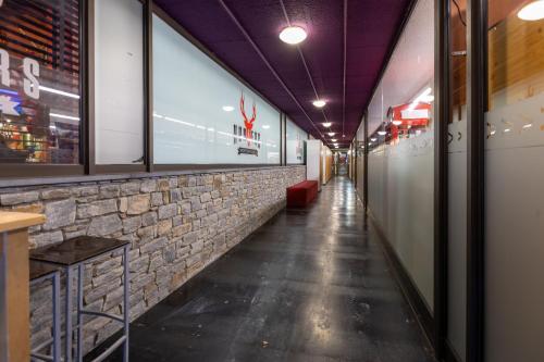 a corridor of a restaurant with a stone wall at Apartaments Sant Moritz in Arinsal