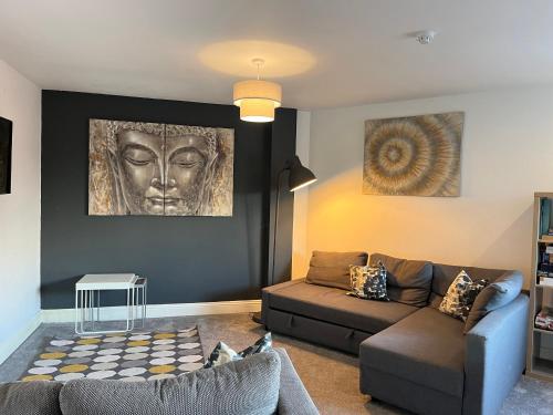 a living room with a couch and a head on the wall at Mia's Place 24 in Chester