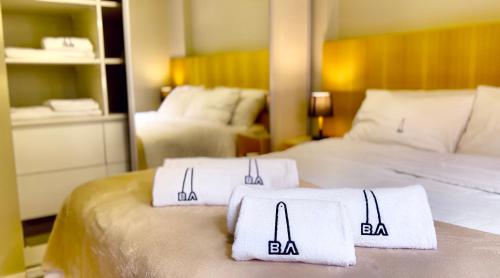 two towels on two beds in a hotel room at Recoleta Center - Moderno Apartamento Buenos Aires in Buenos Aires