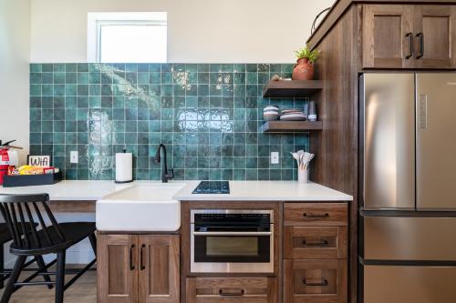 a kitchen with a sink and a refrigerator at Zion Oasis Rentals in Hurricane
