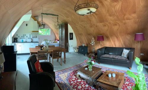 a living room with a couch and a table at Tinyhouse in Bakkeveen in Bakkeveen