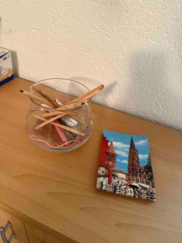 a pair of chopsticks and a book on a table at Geräumige 2-Zimmer Ferienwohnung in Freiburg in Freiburg im Breisgau