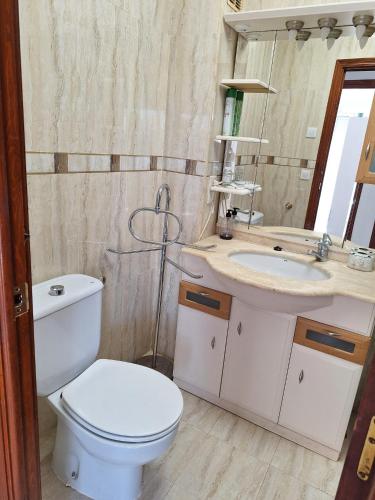 a bathroom with a toilet and a sink at Casa La Mata in Torrevieja