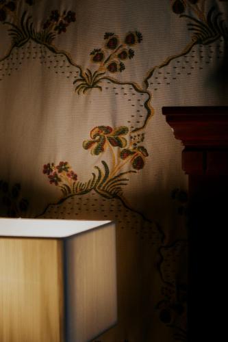 a room with a wall with a floral wallpaper at Le Cedrus Hotel in Al Arz