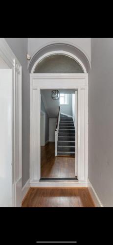 a hallway with a staircase and a mirror in a room at 4bed Townhouse in heart of Sligo in Sligo