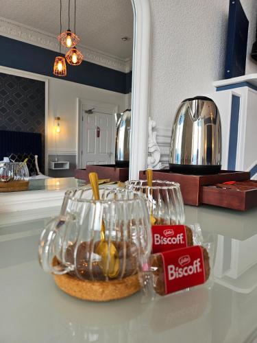 a counter with two wine glasses and a basket of food at MacKays in Oban