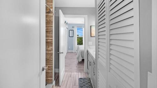 a hallway with a door leading to a bedroom at Infinite Horizons by Last Key Realty in Stock Island
