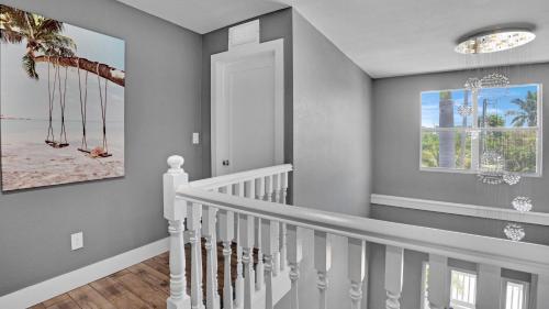 a staircase with white railings in a home at Infinite Horizons by Last Key Realty in Stock Island