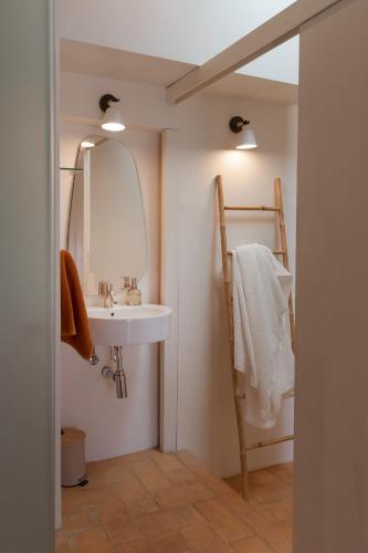 a bathroom with a sink and a mirror at Can Palou in Fornalutx