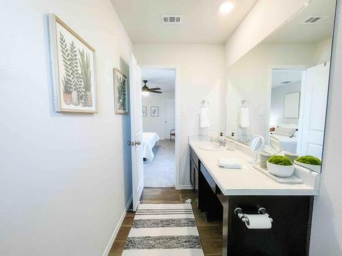 a bathroom with two sinks and a large mirror at Family Modern Oasis Lackland BMT Family Home 3 Bed 2 Bath in San Antonio