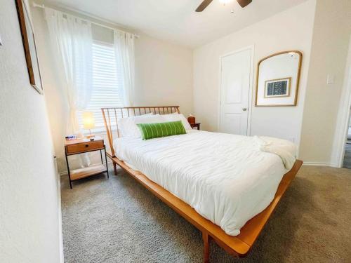 a bedroom with a bed with a mirror and a window at Family Modern Oasis Lackland BMT Family Home 3 Bed 2 Bath in San Antonio