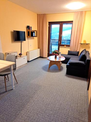a living room with a couch and a table at Ferienhaus Willingen Diemelsee in Diemelsee