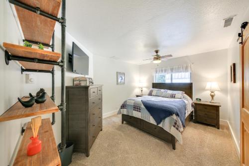 a bedroom with a bed and a dresser at Charming Idaho Home with Hot Tub, Near Beaches! in Sagle