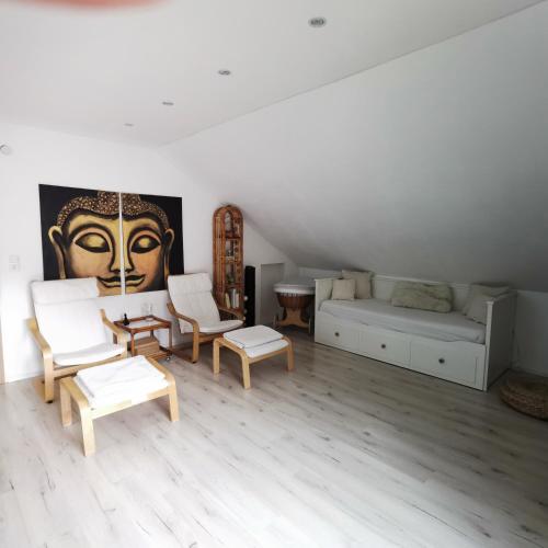 a living room with a couch and a bed at Hennetraum in Meschede