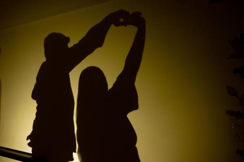 a silhouette of two people doing a handstand at La Mira Casa Karjat in Karjat