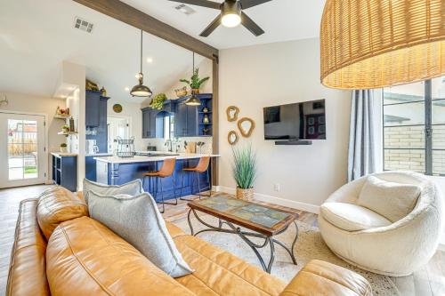 a living room with a couch and a table at 1 Mi to Grand Ave Modern Home with Spacious Yard! in Phoenix