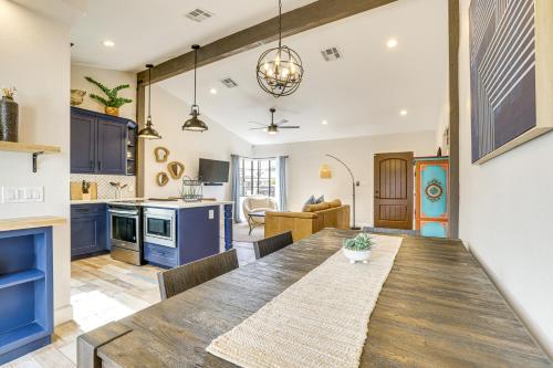 a kitchen and dining room with a wooden table at 1 Mi to Grand Ave Modern Home with Spacious Yard! in Phoenix