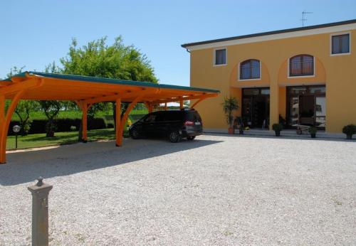 a car parked in a parking lot next to a building at Agriturismo Il Melograno in Tessera