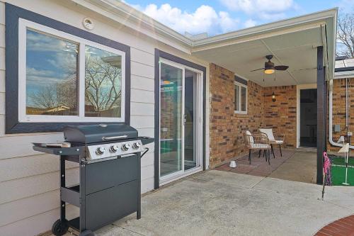 a patio with a grill on a house at Charming 3Bd 2Ba Home with Private Pool in The Colony