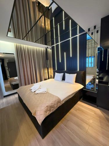 a bedroom with a large bed with two towels on it at Wiślane Tarasy 2 VIP Apartamenty JACUZZI in Krakow