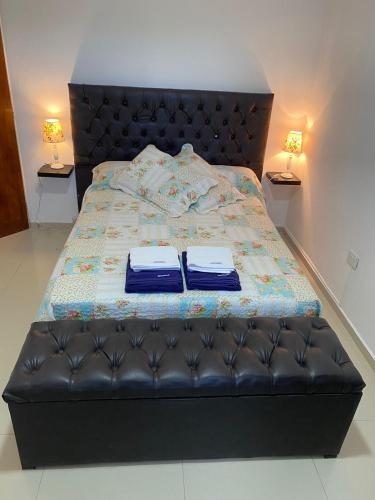 a bedroom with a bed with two robes on it at Apartamentos Anahí in Villa Parque Siquiman