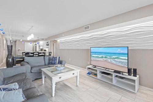 a living room with a couch and a flat screen tv at 317 - Fantastic 3 BR Oceanfront Corner in Edgewater