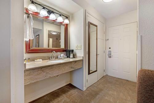 a bathroom with a sink and a mirror at Best Western Plus Concord Inn in Minocqua
