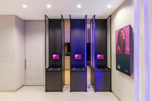 a room with two refrigerators with screens on them at YOTEL Tokyo Ginza in Tokyo