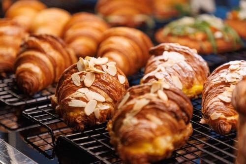 a bunch of croissants and pastries on a cooling rack at YOTEL Tokyo Ginza in Tokyo