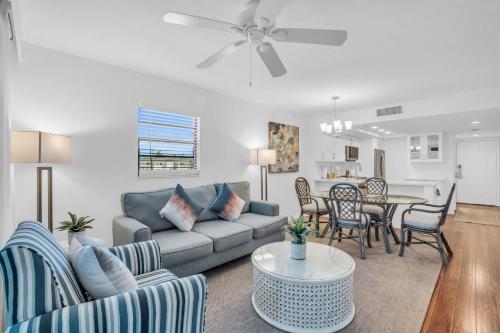 a living room with a couch and a table at Corner Unit Updated And Near Lobby in Naples