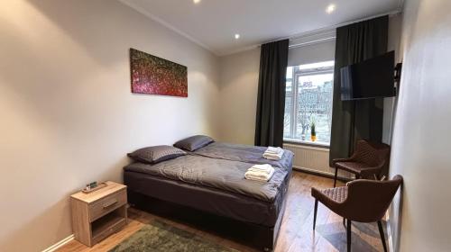 a small bedroom with a bed and a window at City Guesthouse in Reykjavík