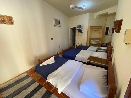 a bedroom with three beds in a room at Safari Camp Bahariya Oasis in Bawiti
